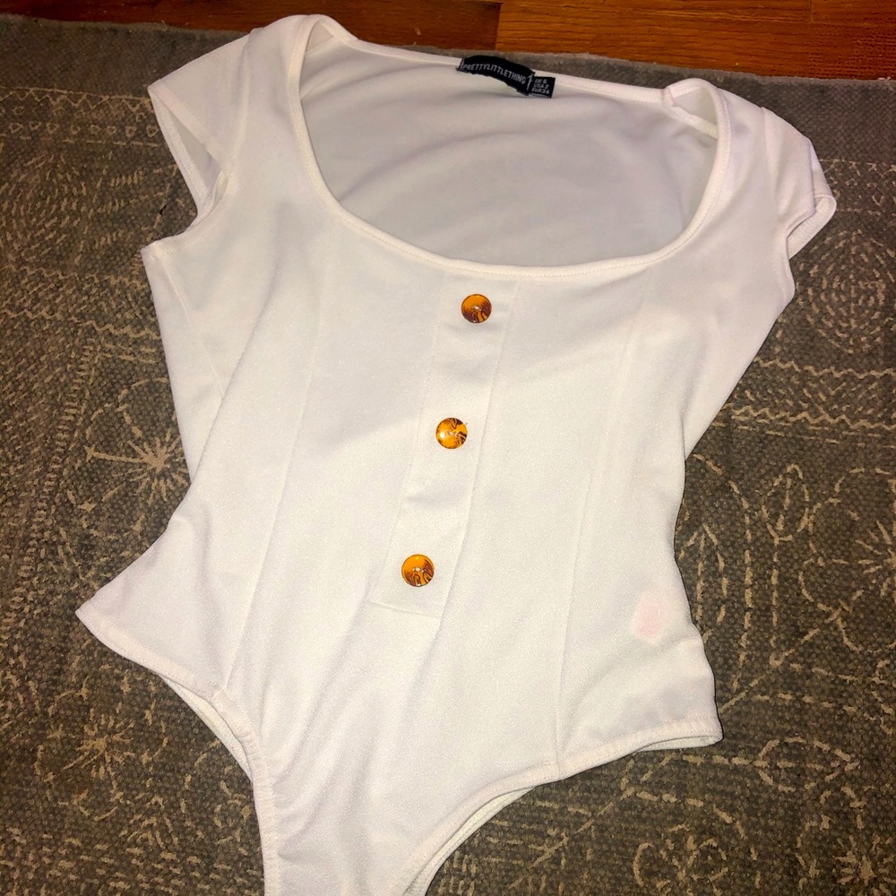White bodysuit with brown buttons